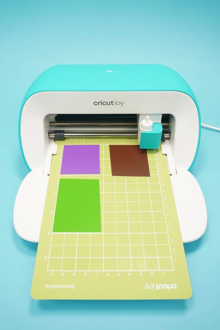 cricut joy and cutting mat with scrap vinyl materials