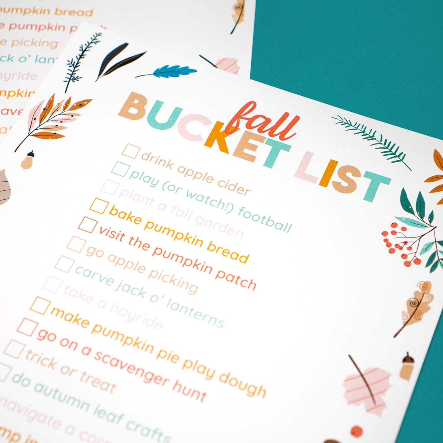 close up of printable fall bucket list on teal background