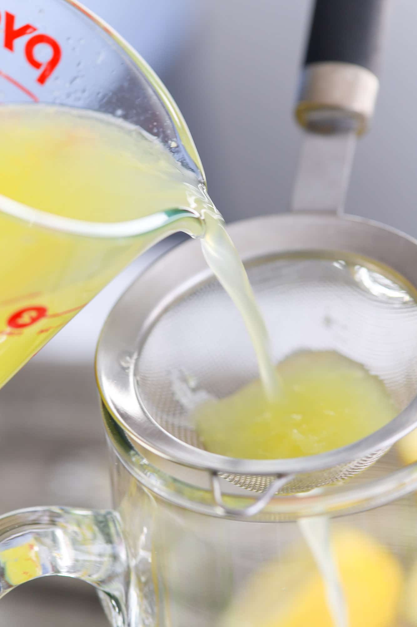 fall hard lemonade being poured into strainer