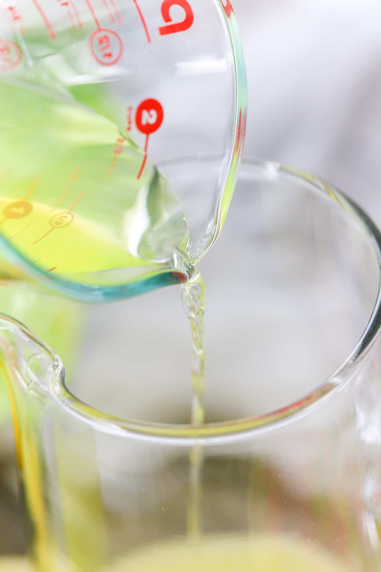 Pouring liquid from a measuring cup into a pitcher