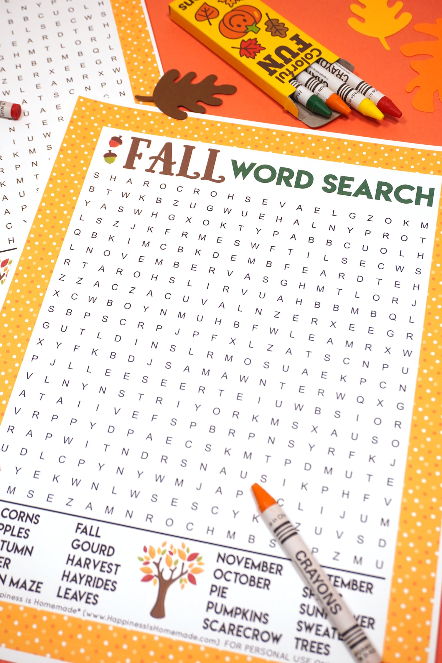 Fall Word Search Printable on dark orange background with orange crayon surrounded by paper leaves