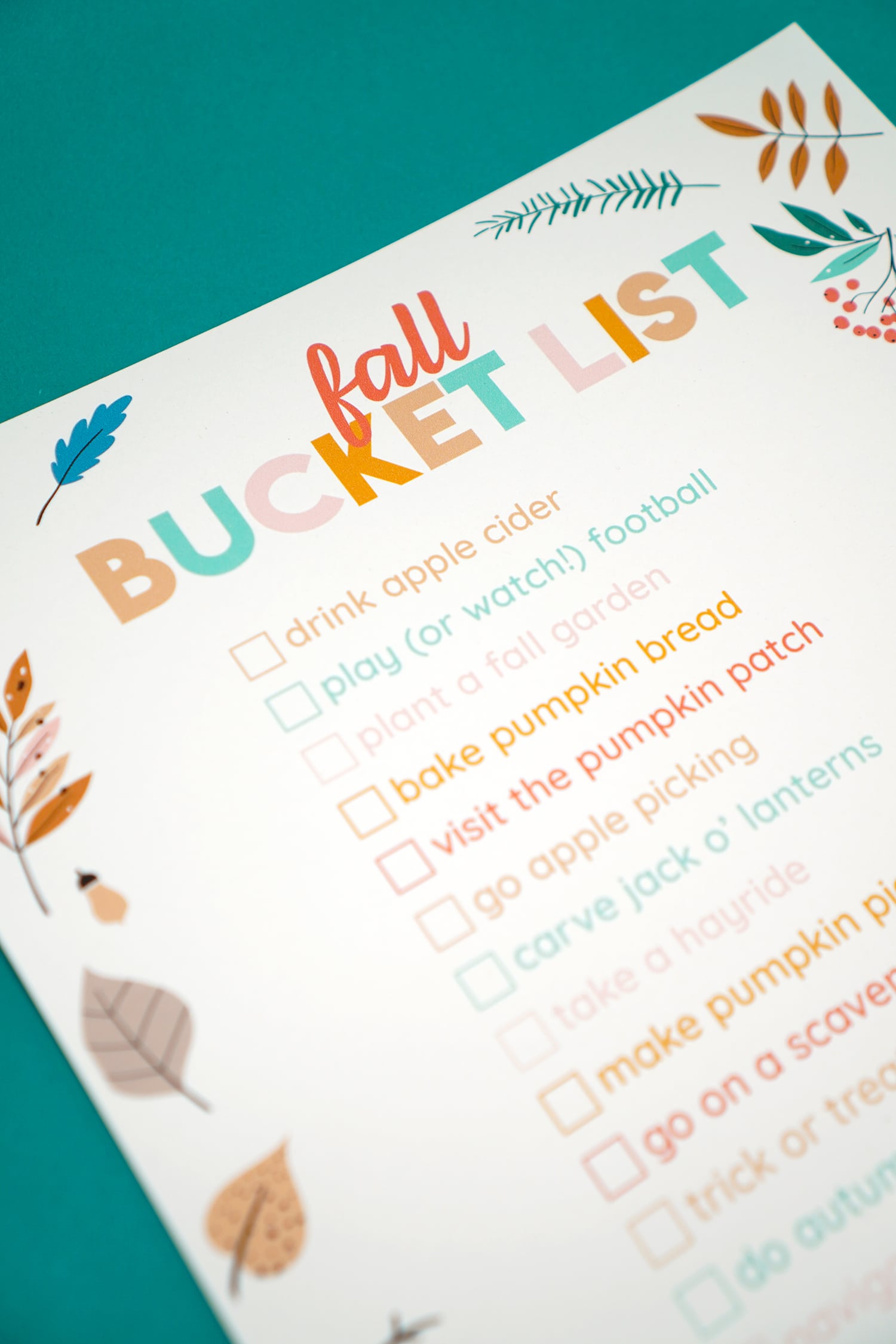 close up of printable fall bucket list on teal background