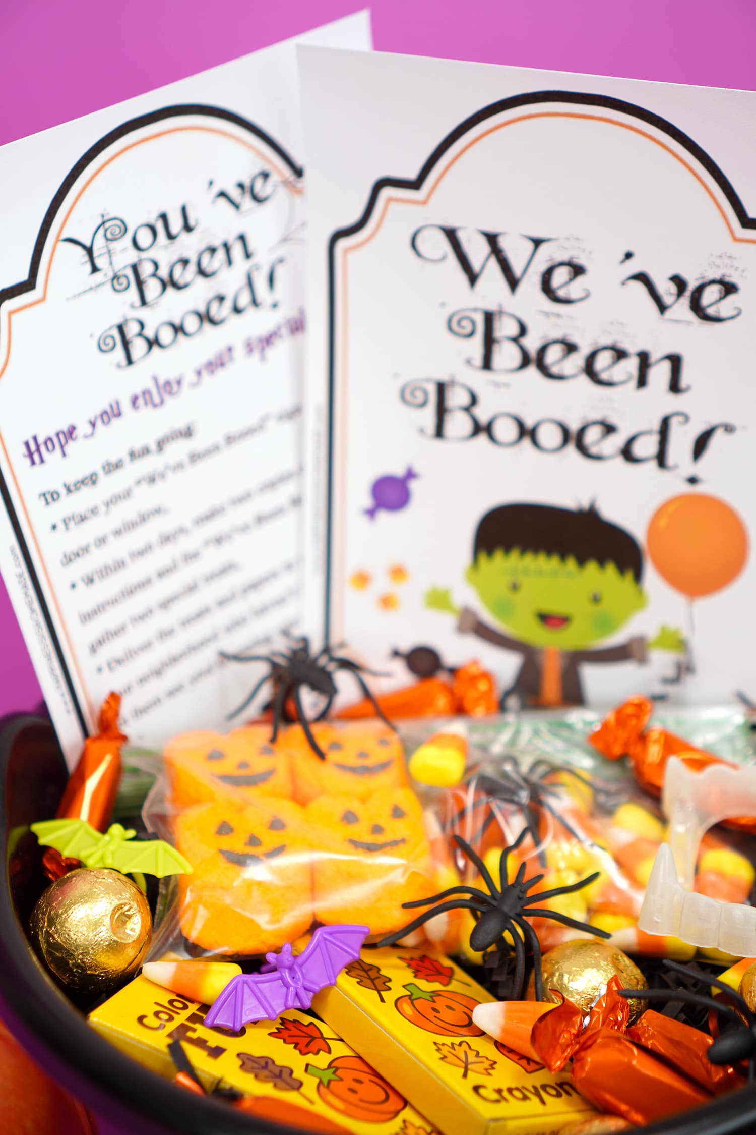 Boo Basket filled with Hallowen candy and novelty toys with "You've Been Booed"and " We've Been Booed" printable signs