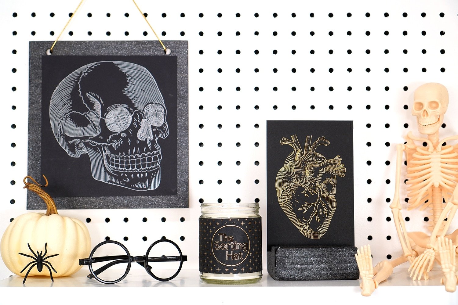 Shelves decorated with Halloween props and Halloween foil art prints