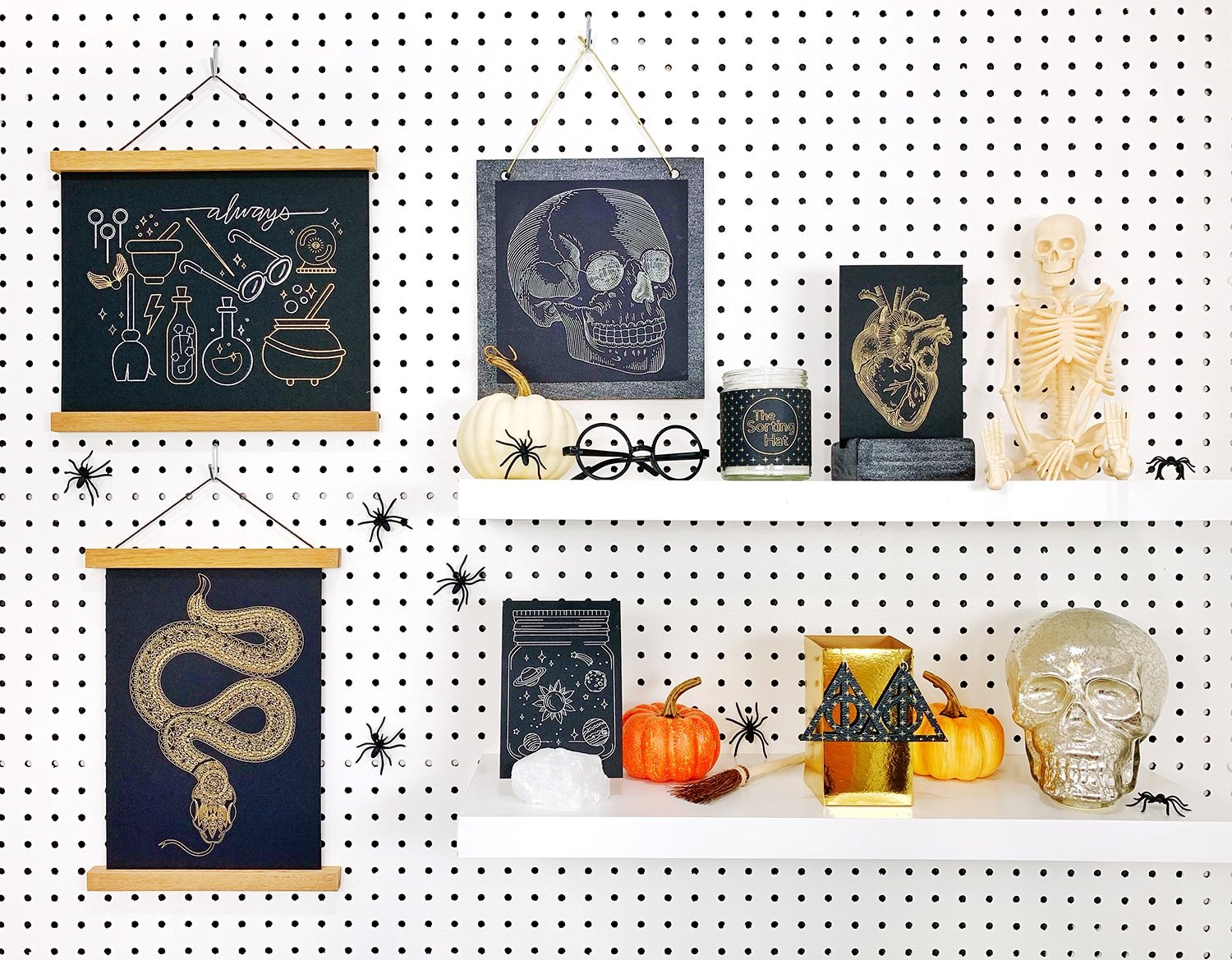 Shelves decorated with Halloween props and Halloween foil art prints