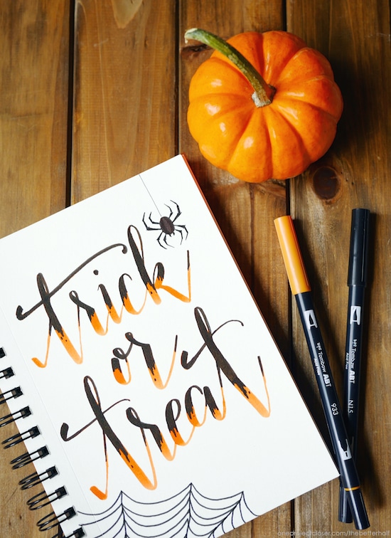 halloween printable trick or treat project in binder with pens and pumpkin