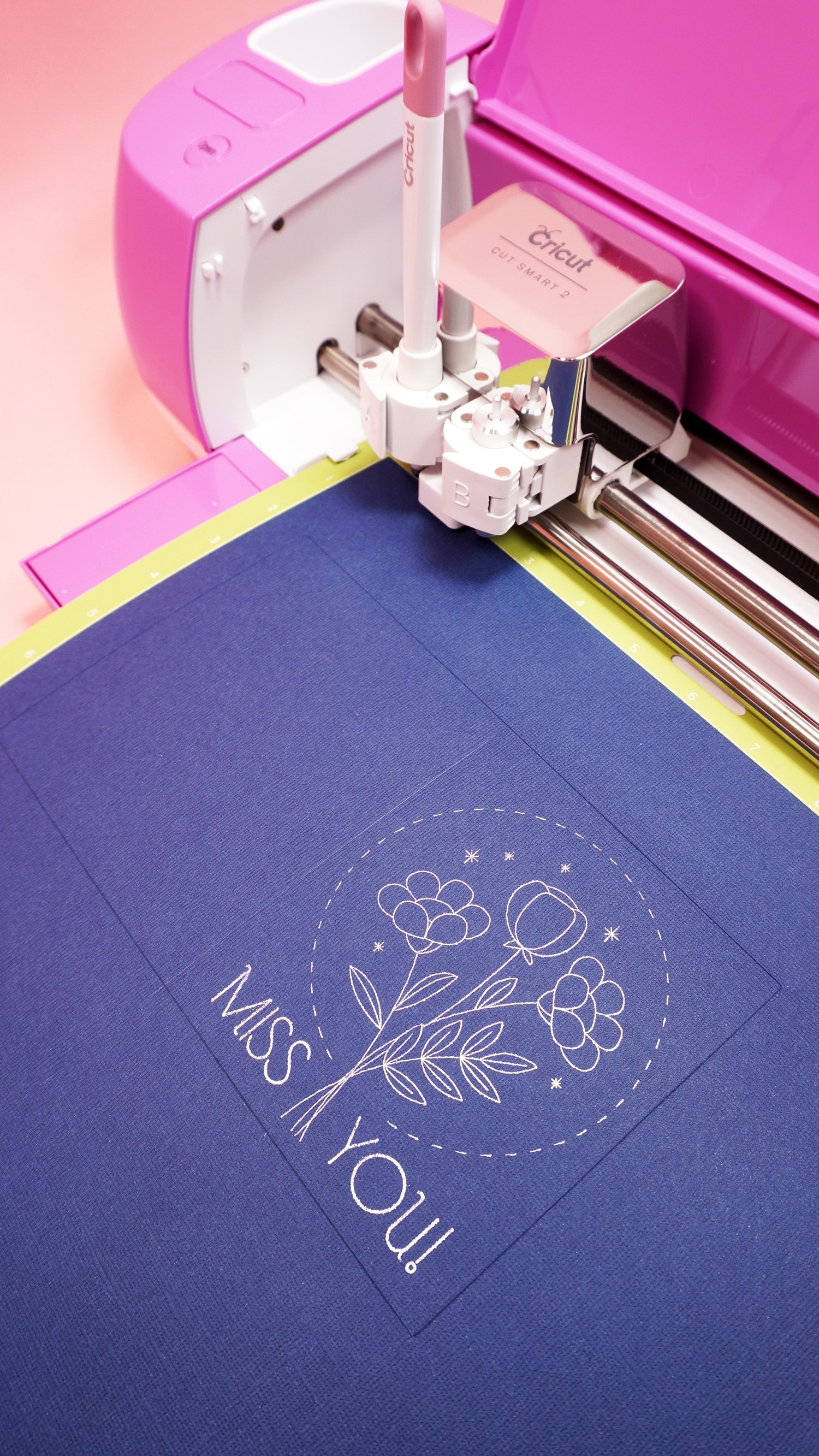 Navy blue "Miss You" card on mat in pink Cricut Explore Air 2 machine