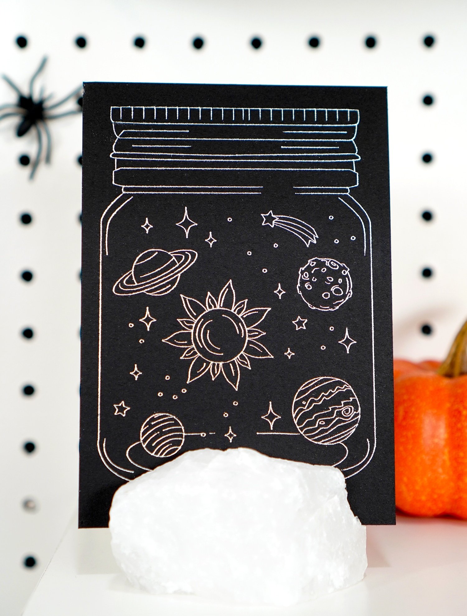 Black and silver galaxy in a jar foil art print in white quartz stand