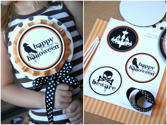 girl holding printable halloween sign and printable on table