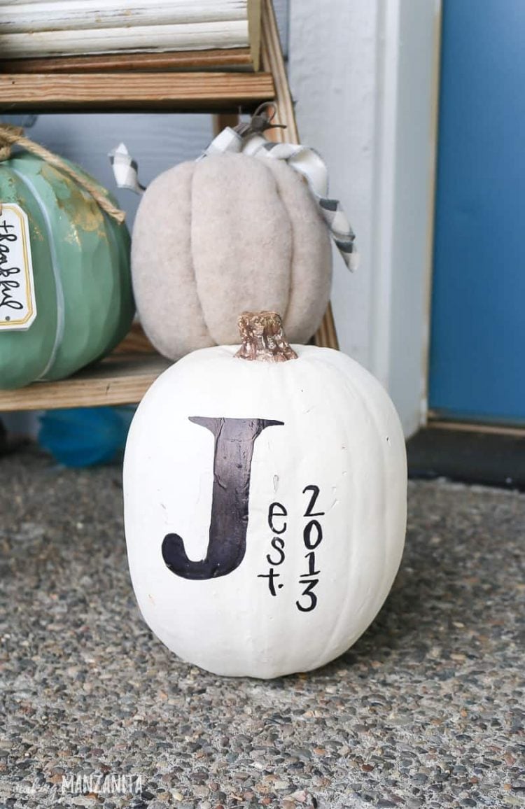 white pumpkin decorated with a J and est 2013
