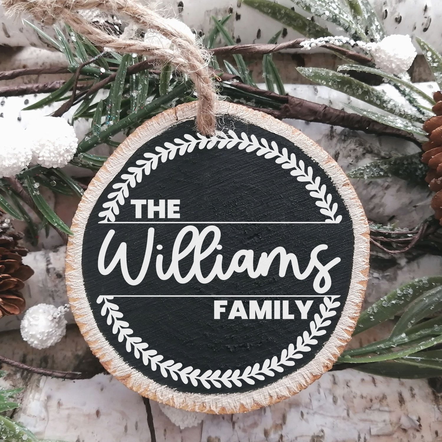 Chalkboard painted wood slice Christmas ornament with "The Williams Family" and wreath design