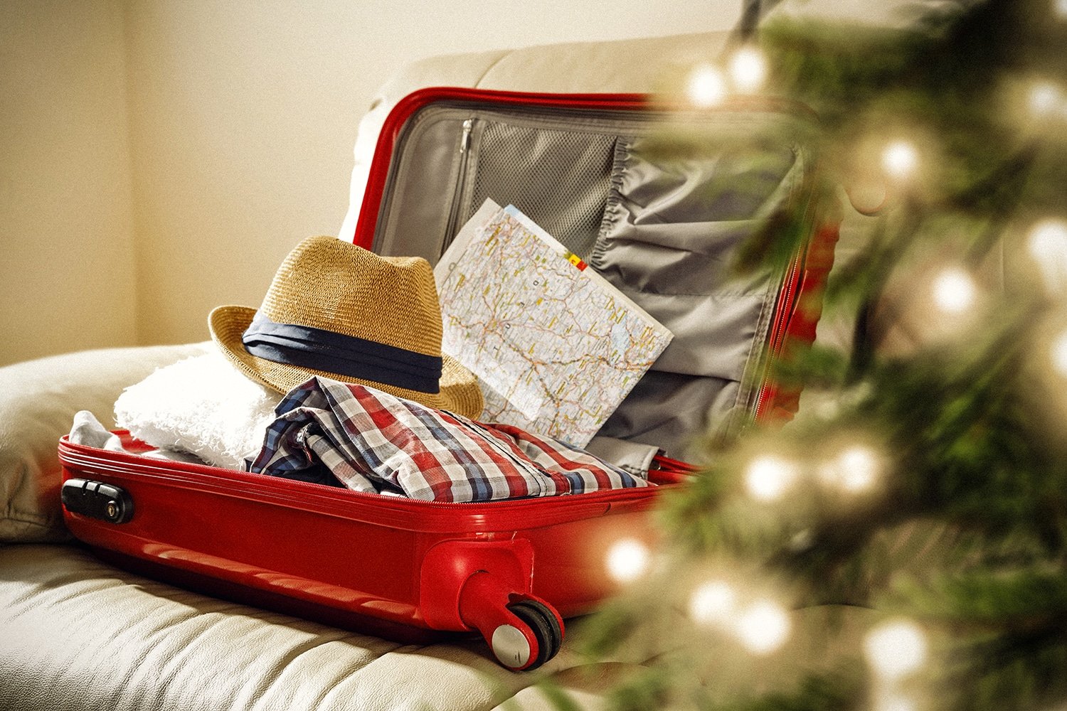 christmas travel bag packed in front of christmas tree