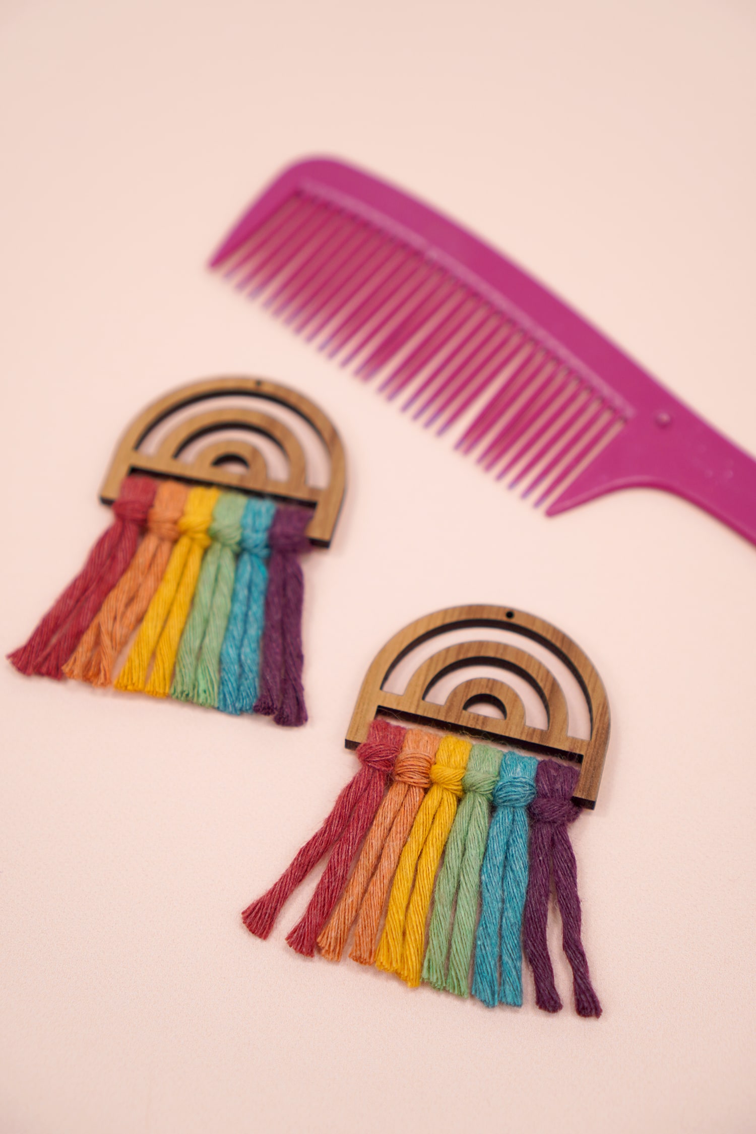 Rainbow macrame earrings with unbrushed macrame cord and pink comb in background