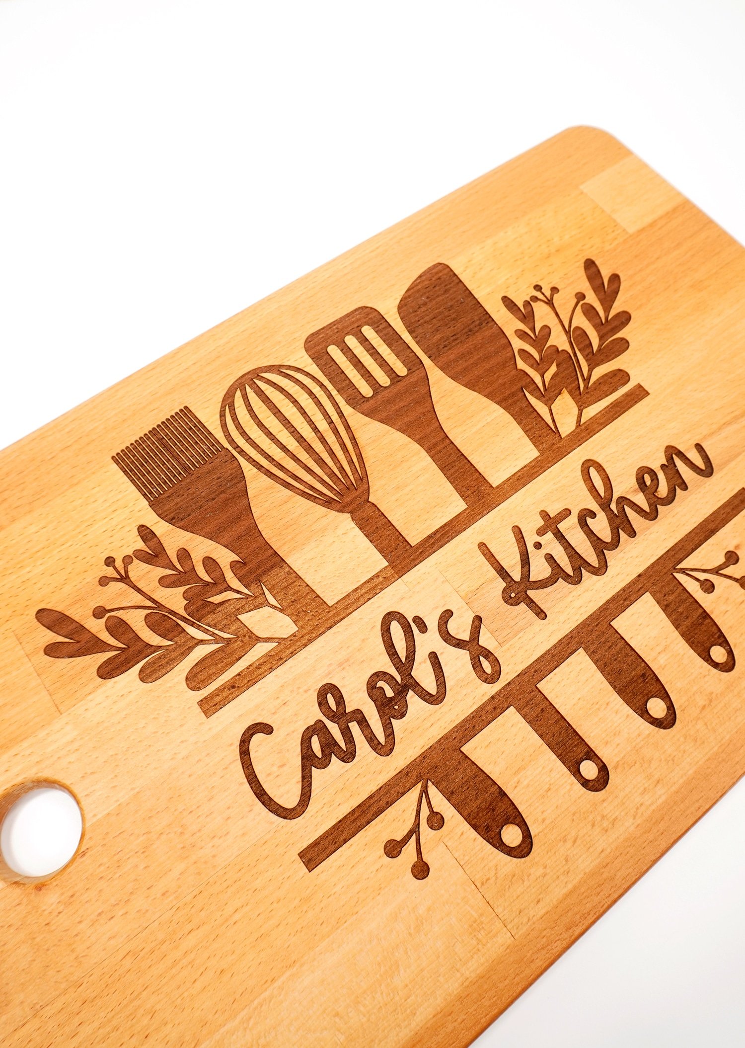 Glowforge Engraved Ikea Cutting Board with "Carol's Kitchen" design on white background