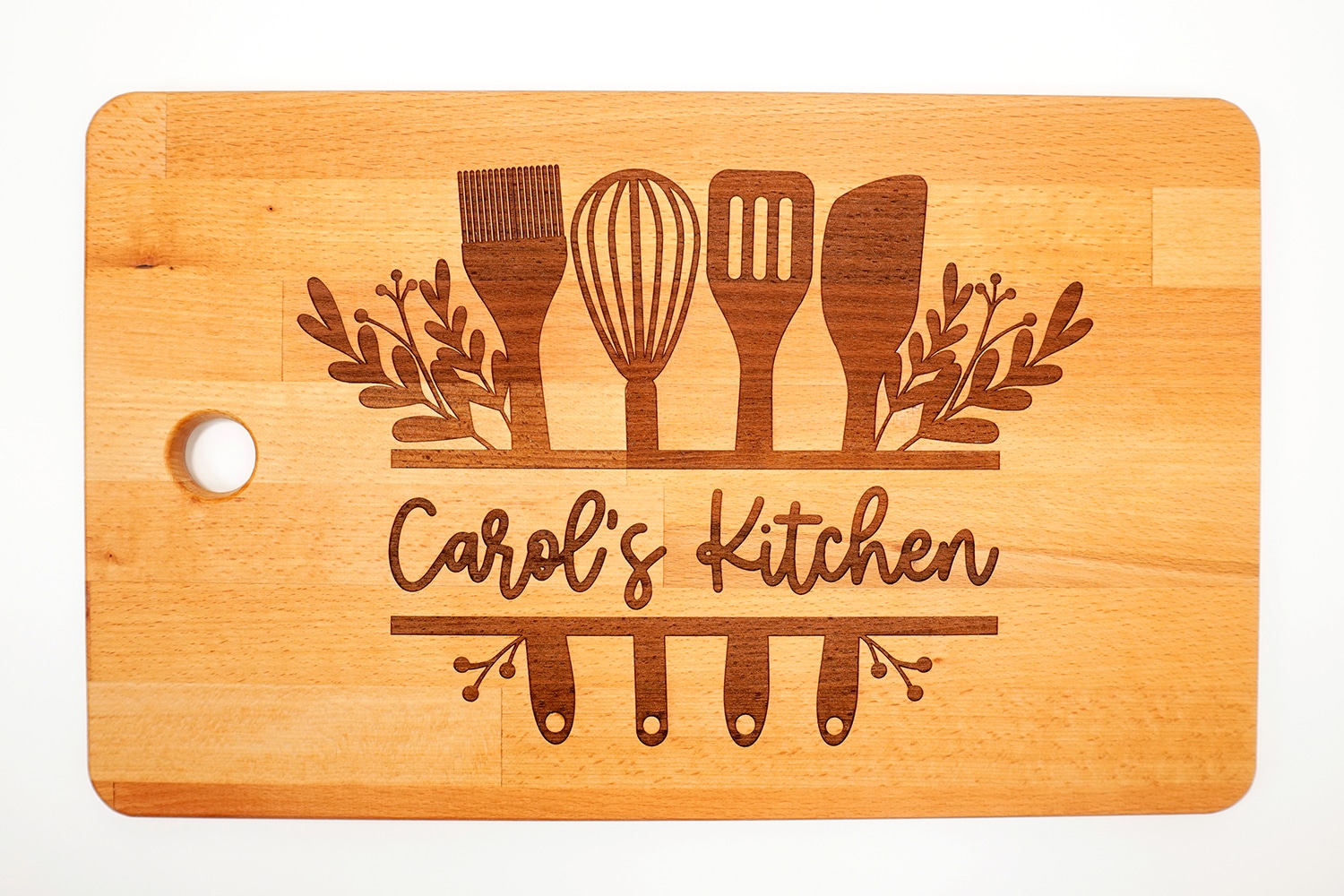 Glowforge Engraved Ikea Cutting Board with "Carol's Kitchen" design on white background