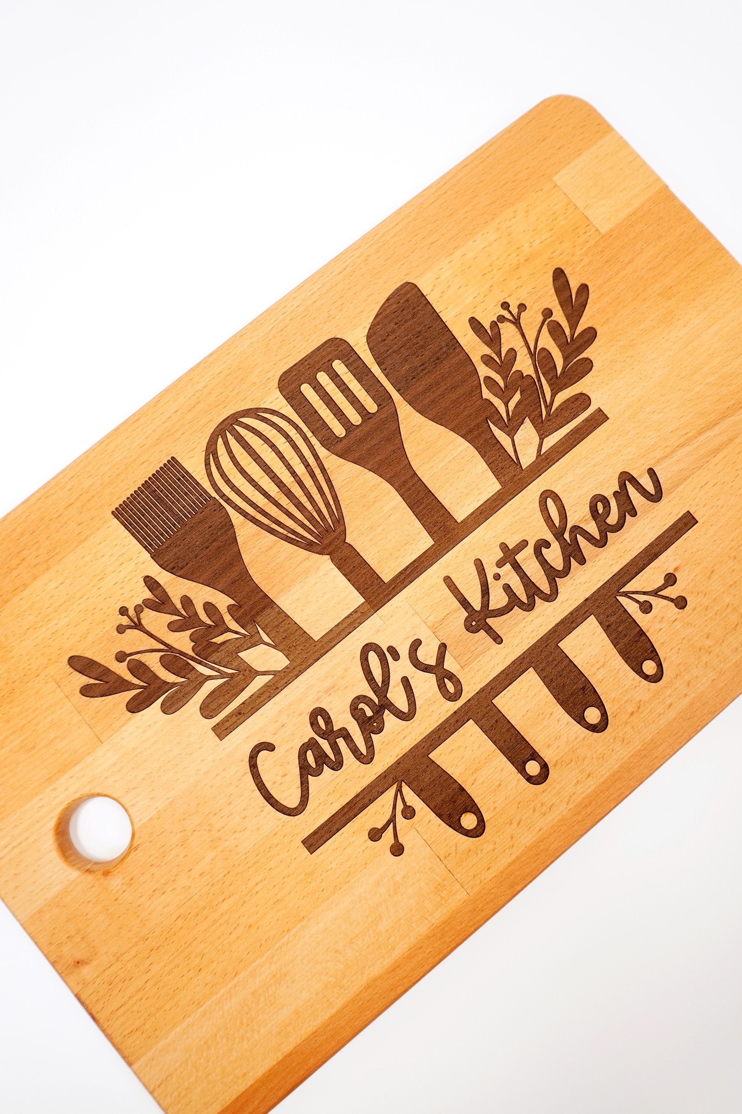 Glowforge Engraved Ikea Cutting Board with "Carol's Kitchen" design on white background