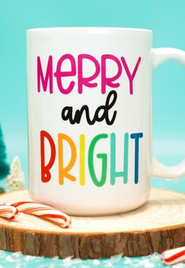 merry and bright mug on wood round with christmas decor