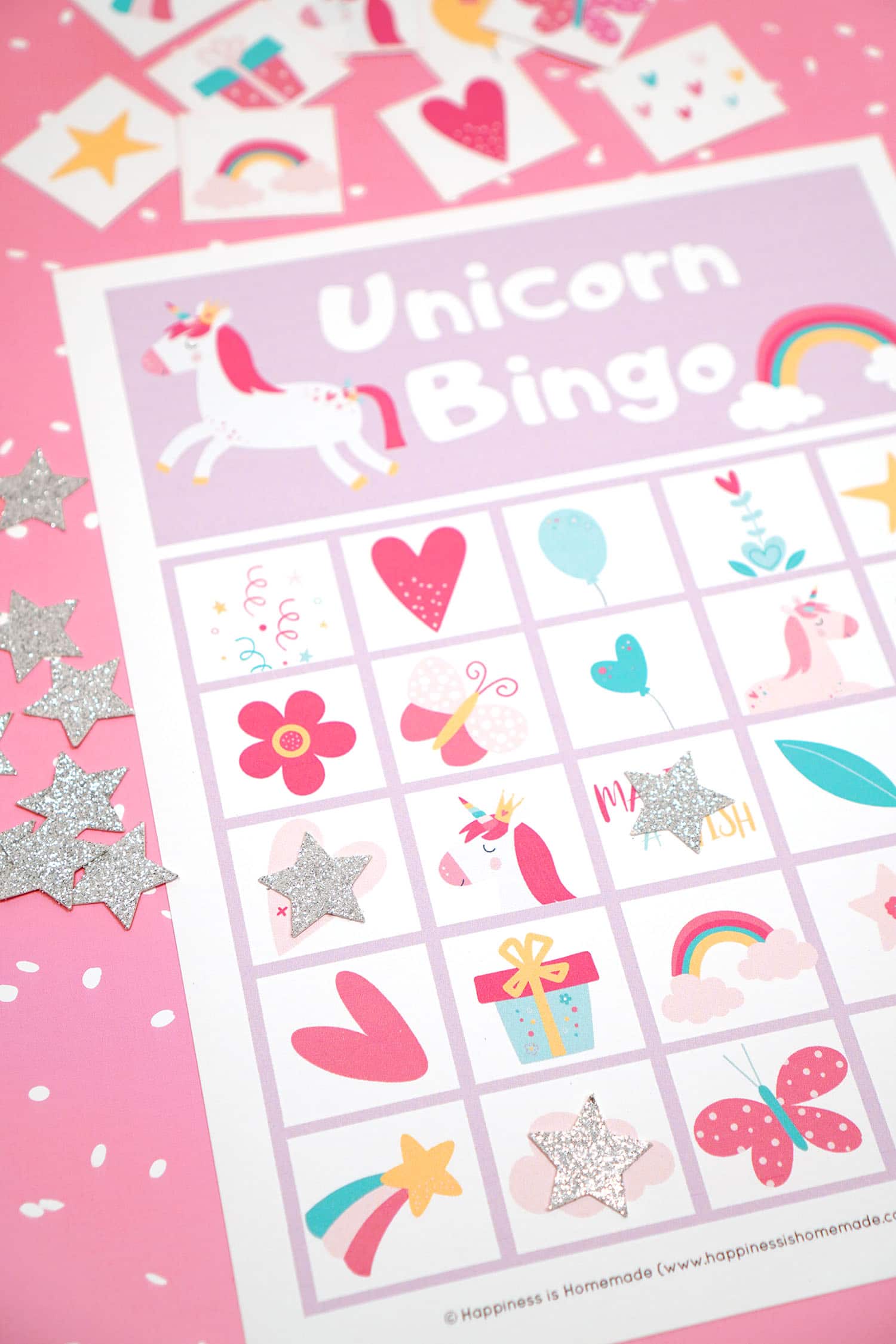 Printable Unicorn Bingo Game Cards on pink background with silver star markers and calling cards