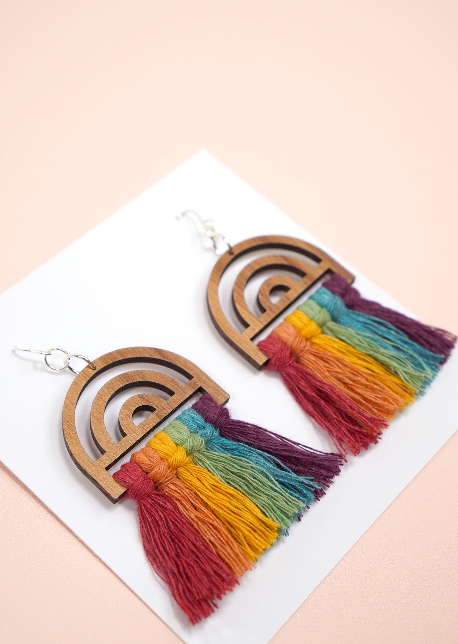 Rainbow Macrame Earrings with Wood Findings on peach background