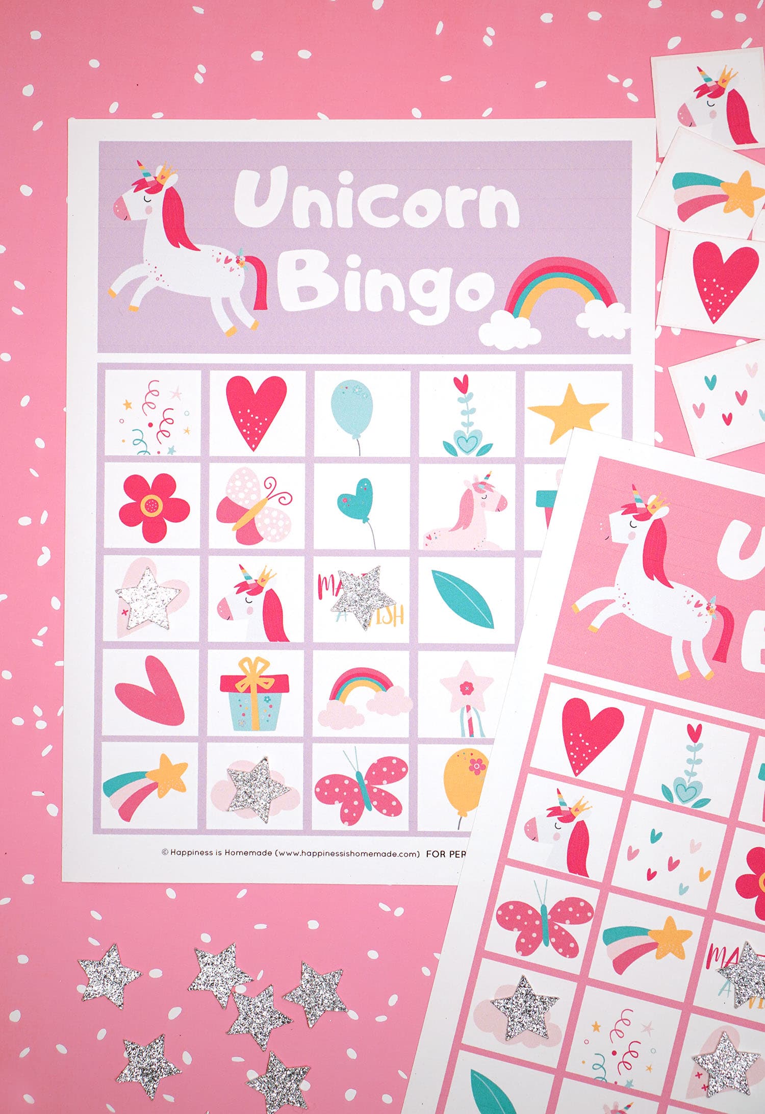 Printable Unicorn Bingo Game Cards on pink background with silver star markers and calling cards