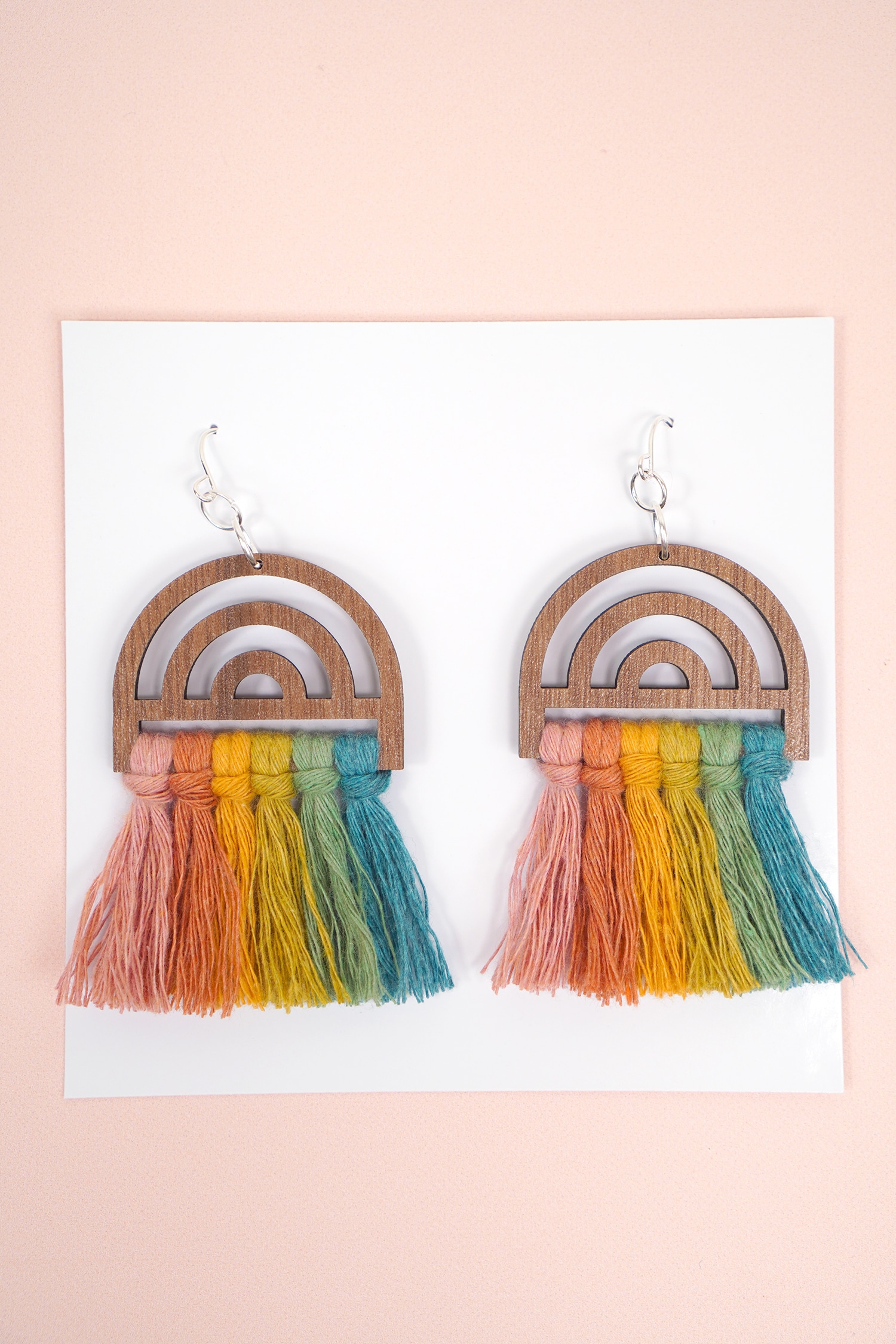 Wooden Rainbow Macrame Earrings on Peach Background