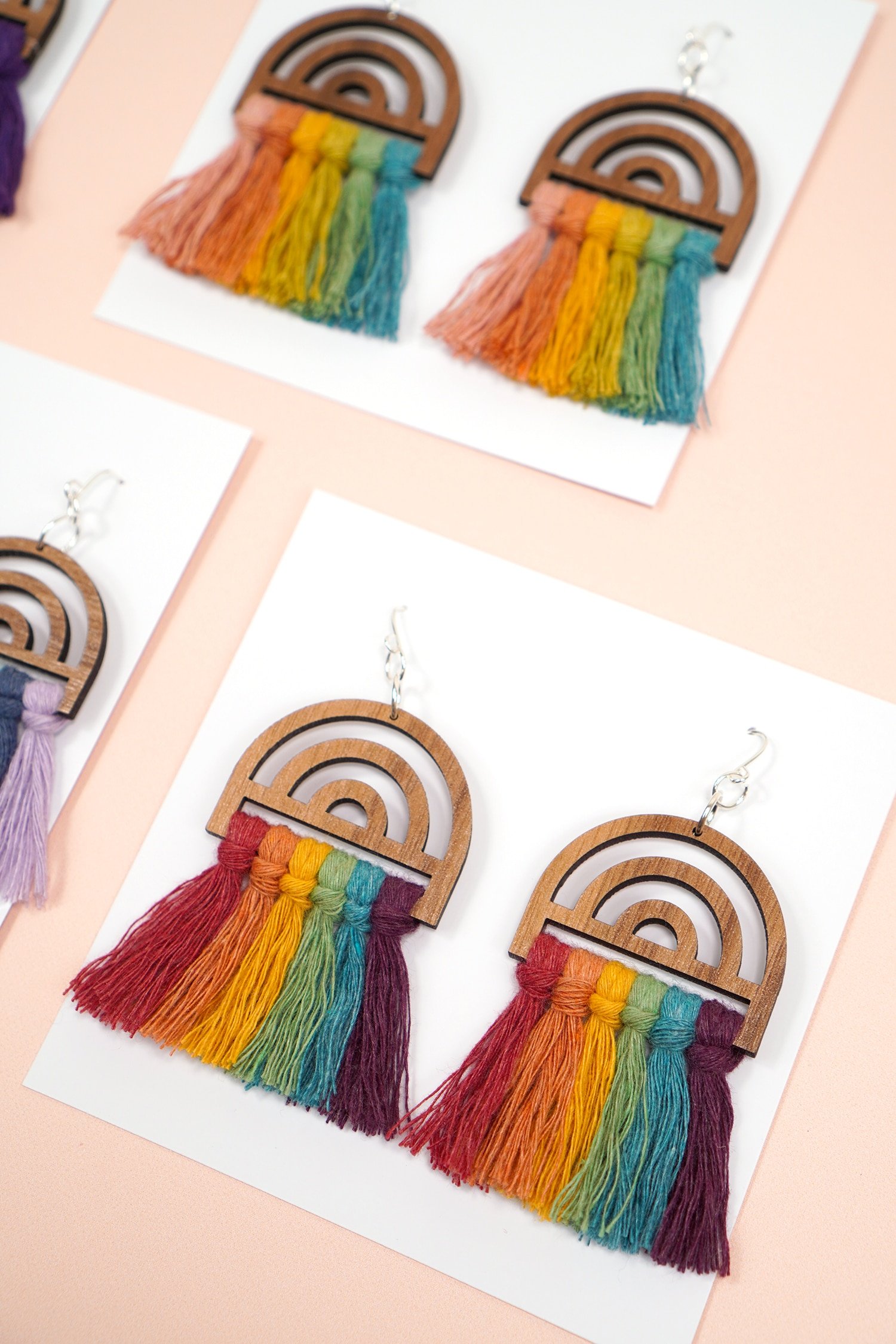 Wooden Rainbow Macrame Earrings on Peach Background