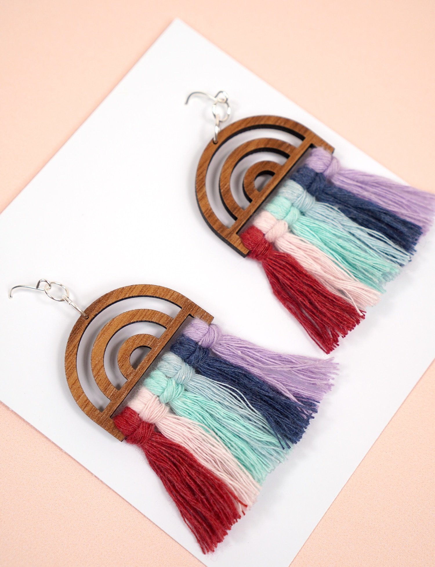 Wooden Rainbow Macrame Earrings on Peach Background