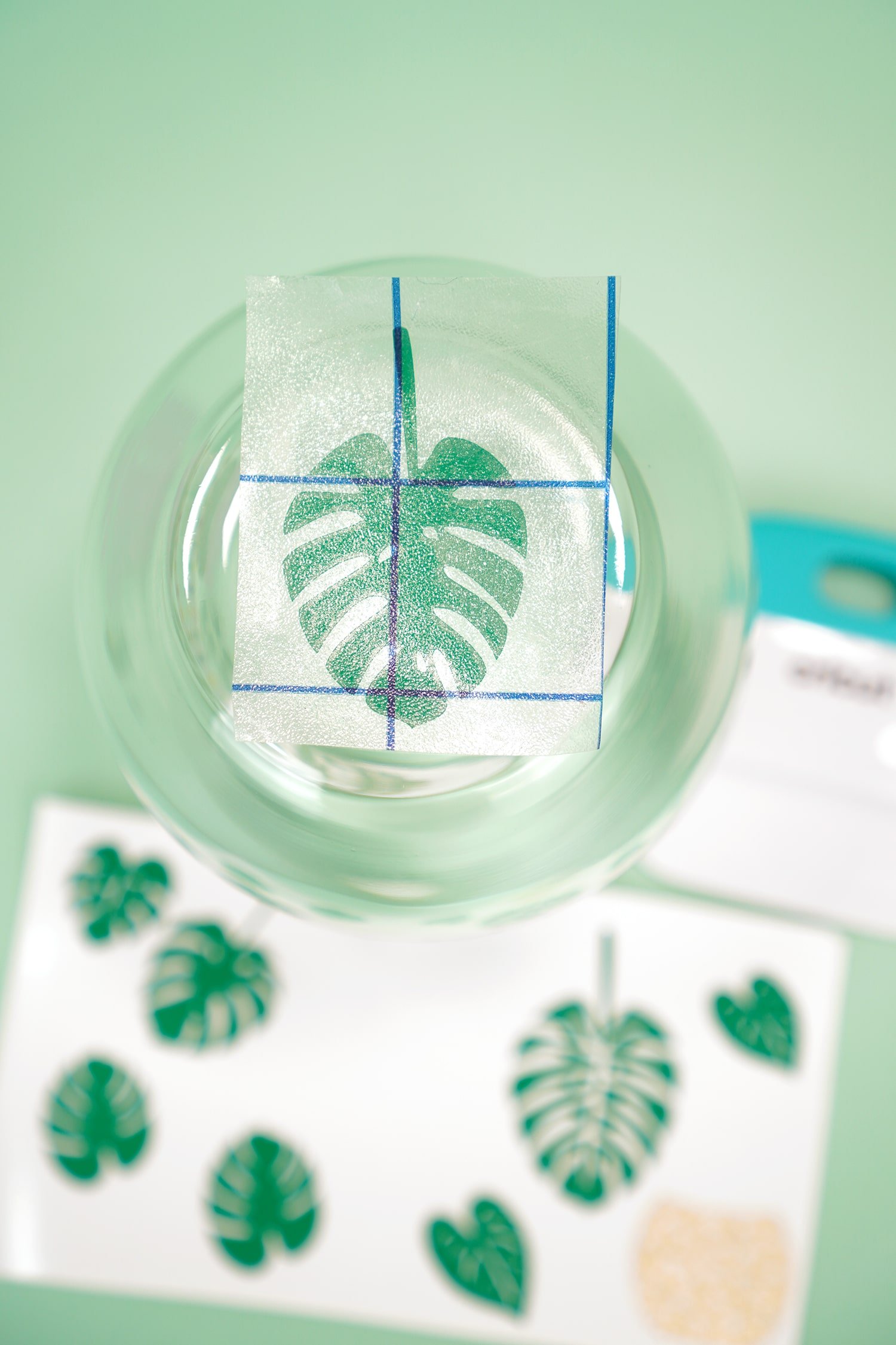 Applying a leaf decal to the bottom of an upside down stemless wine glass