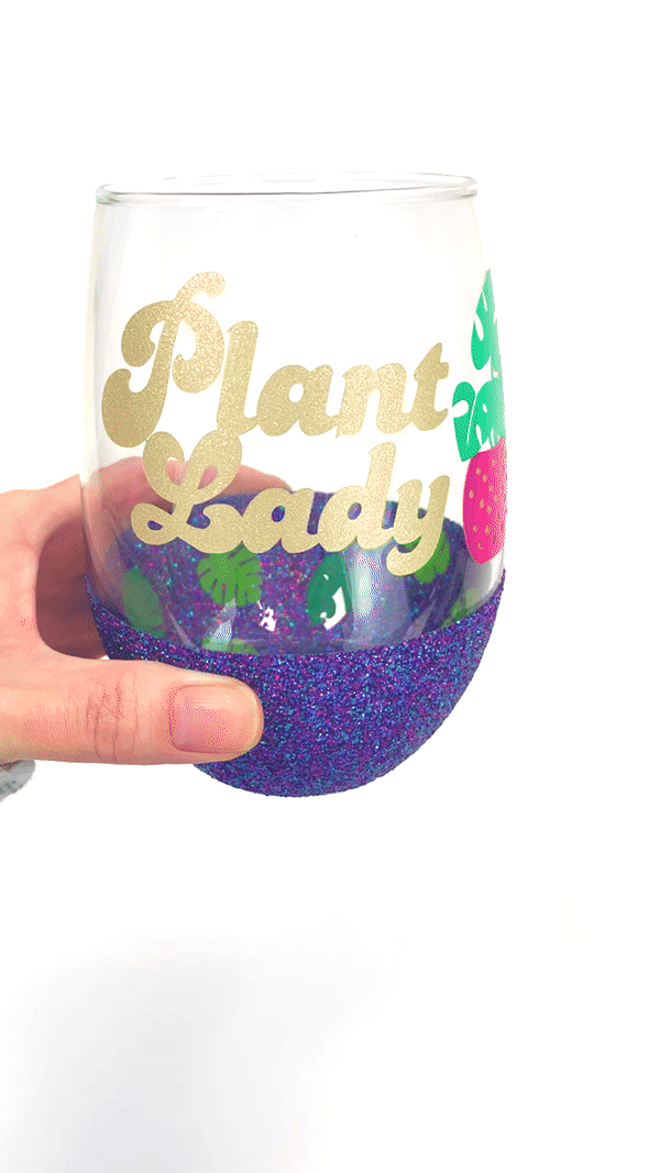 plant lady peekaboo glitter wine glass being tilted to show leaves inside cup