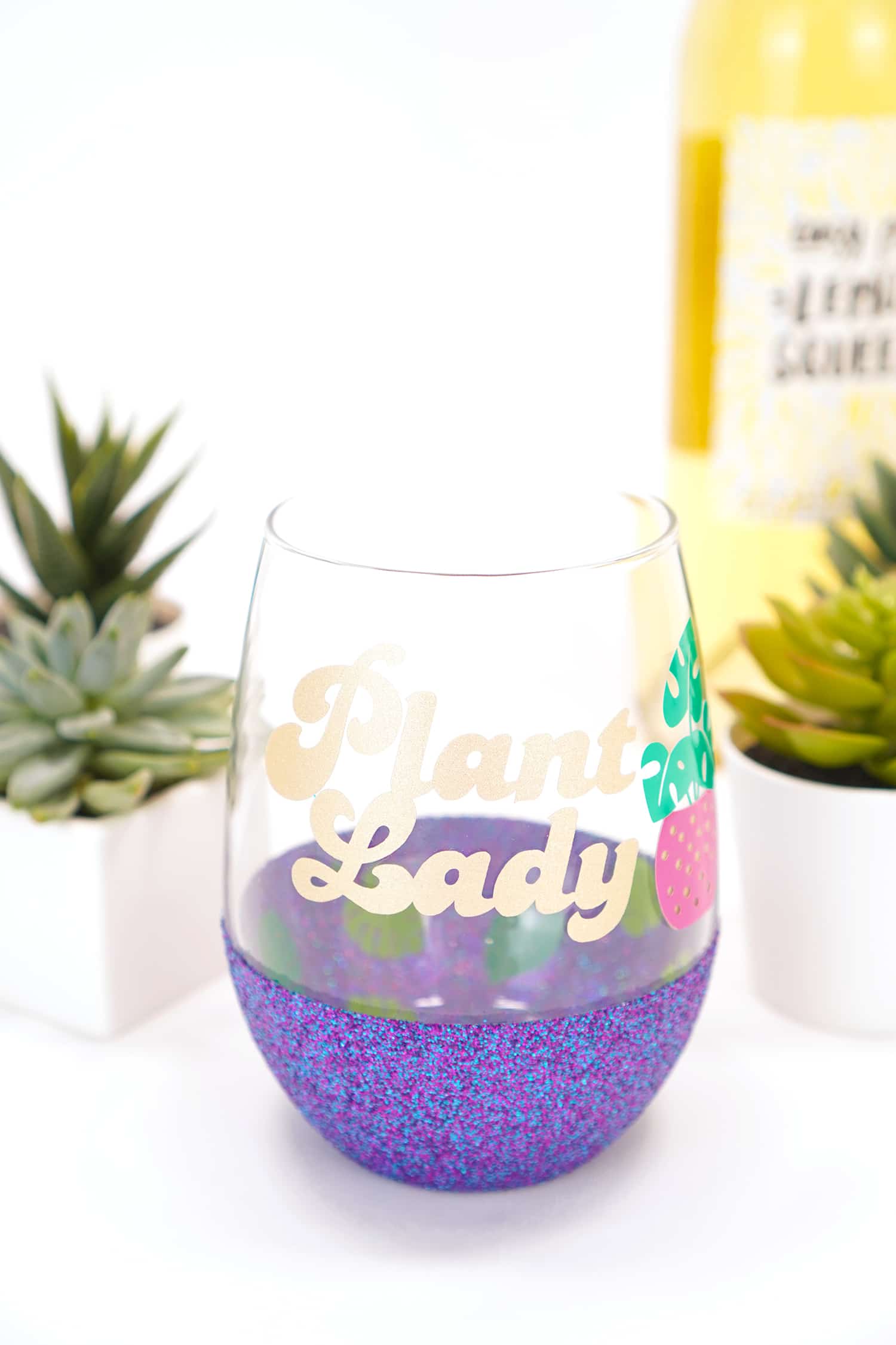 Plant Lady Wine Glass with Gold Text - plants and wine bottle in background