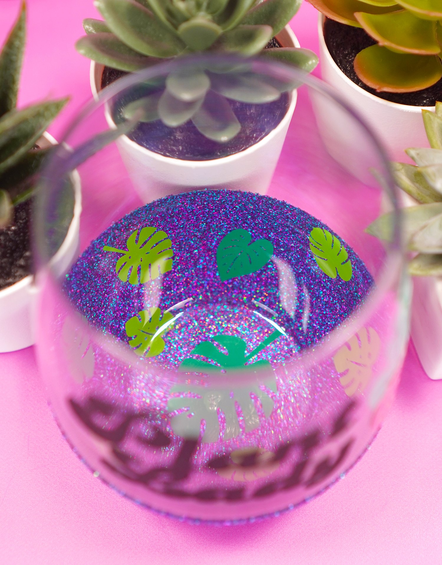 Inside of "Plant Lady" peekaboo wine glass - two toned monstera leaf decals on purple glitter