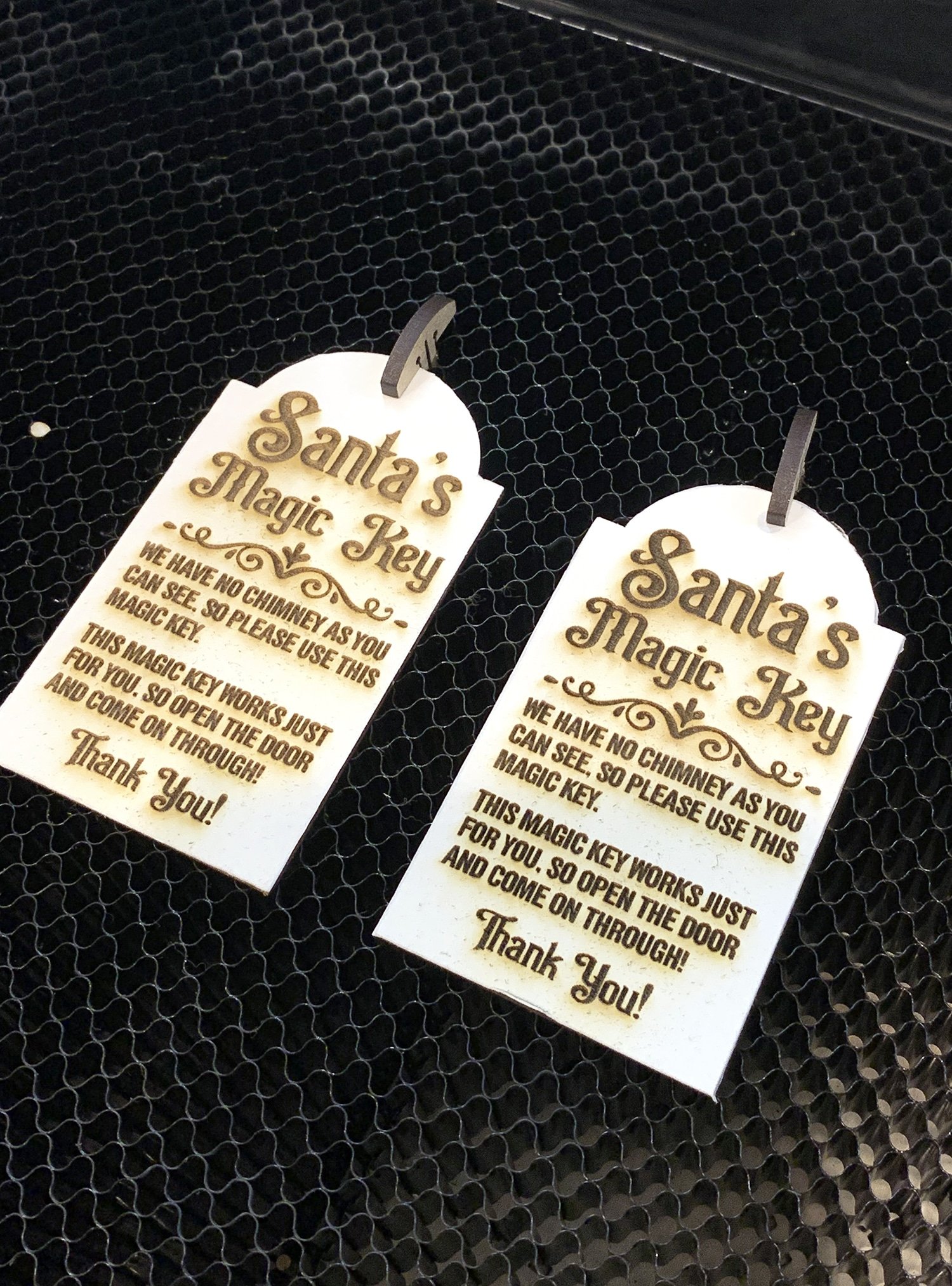 pre cut tags in glowforge machine for santa keys