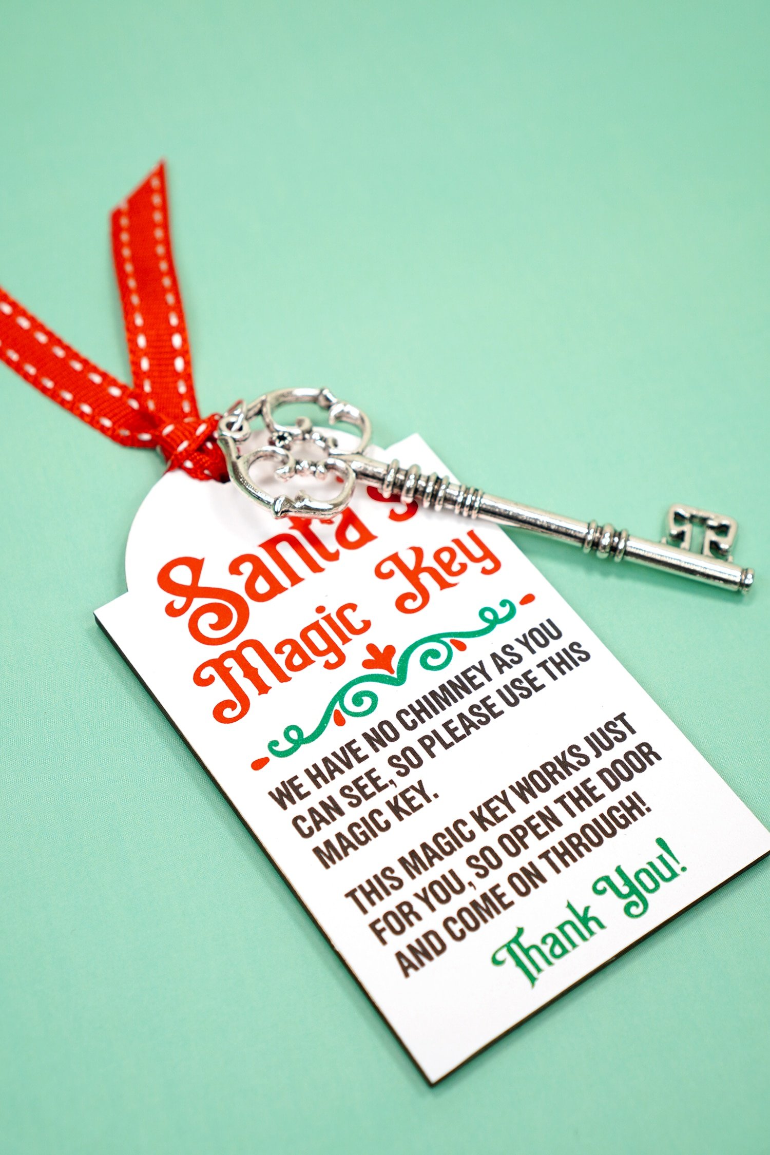 Printable Santa's Magic Key with red ribbon and silver key on mint green background