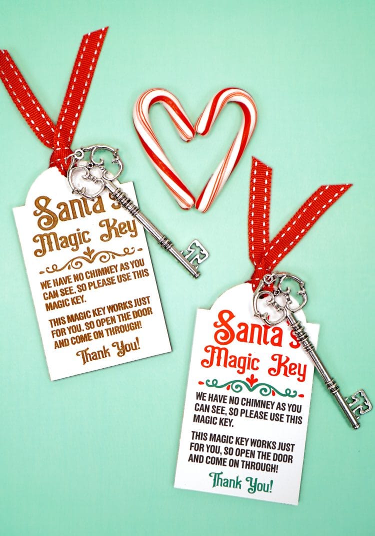 Two Santa's Magic Key tags with red ribbons and silver keys on a mint green background with candy canes