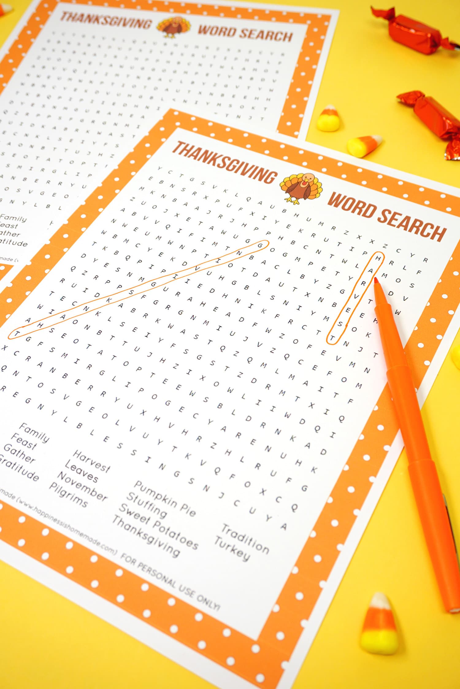 Printable Thanksgiving Word Search puzzle game with \"harvest\" and \"Thanksgiving\" circled on yellow background with orange pen and candy