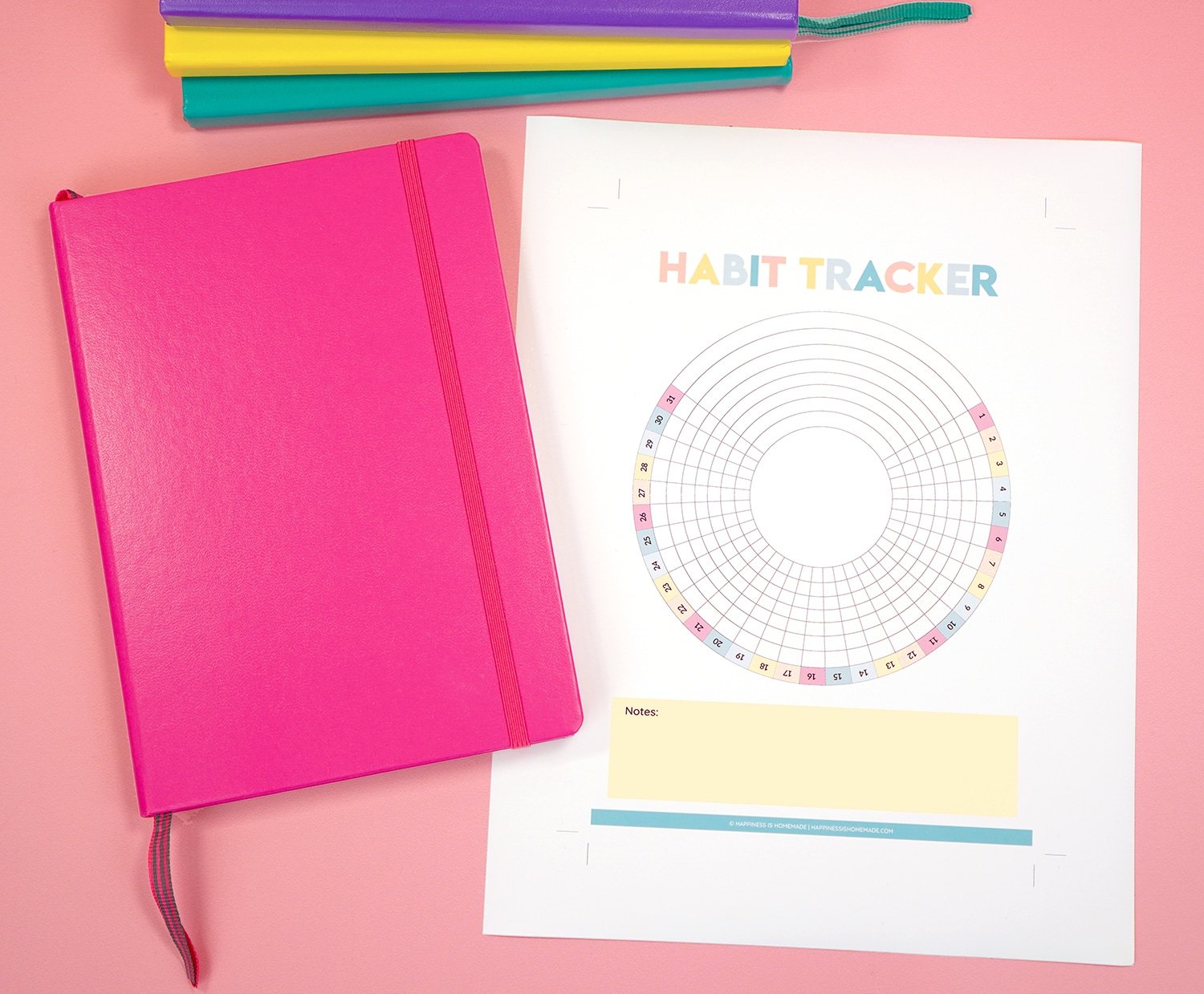 Printable Habit Tracker and bright pink bullet journal on light pink background