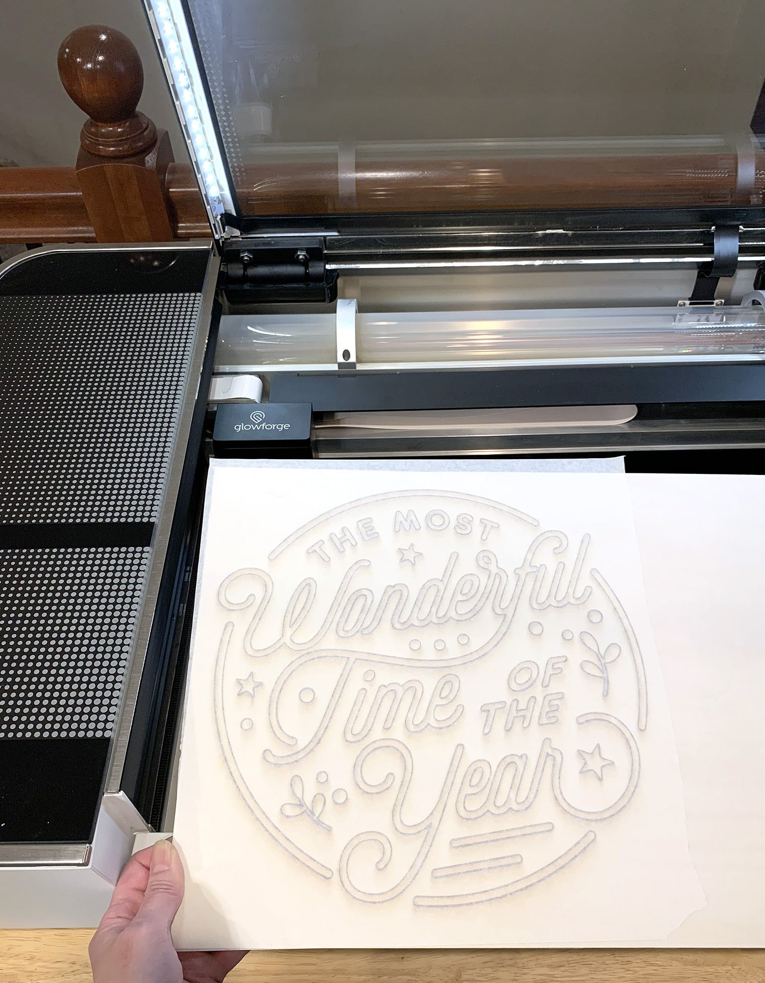 Hand Removing a Laser Cut Wood Sign from Glowforge