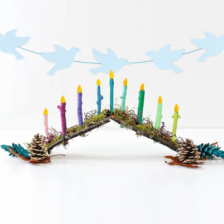 nature inspired menorah made from pine cones, sticks, and more