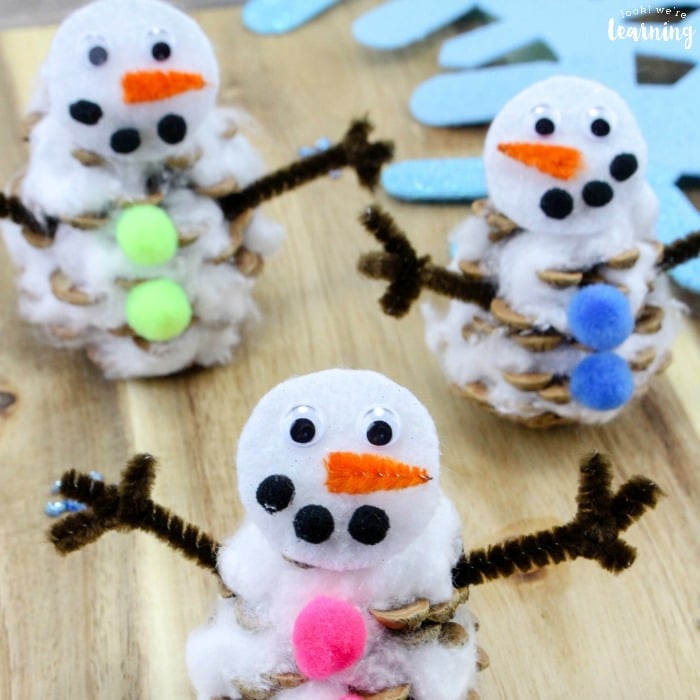 snowmen made from pine cones and pom poms