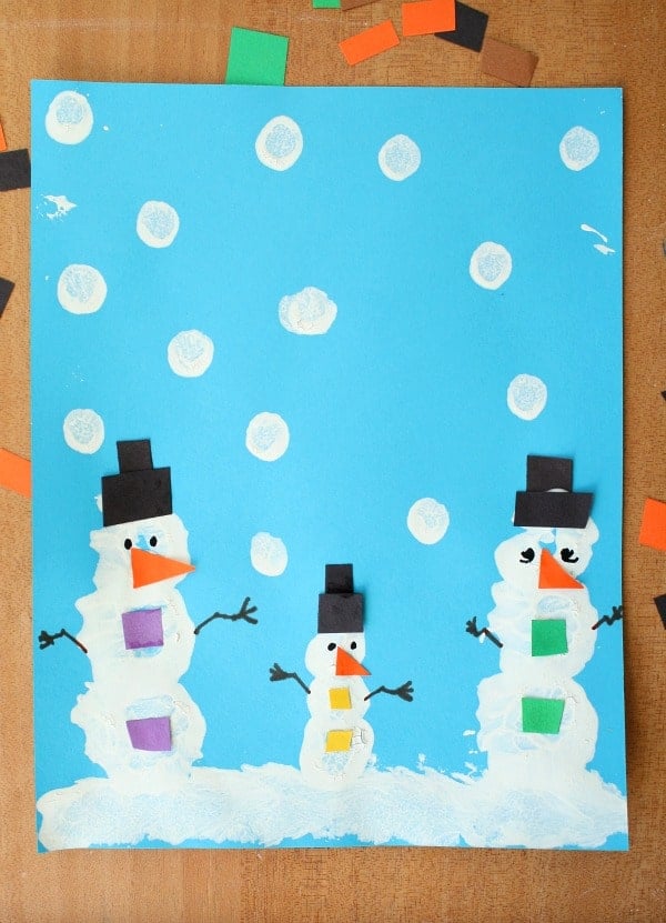 pom pom painted snowman on snowy picture background