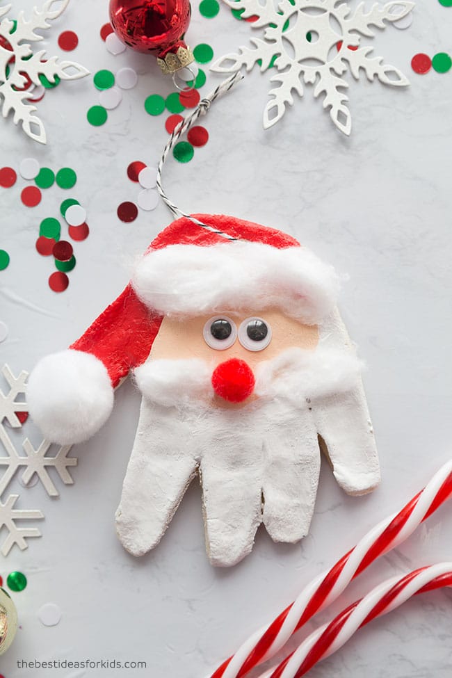 handprint salt dough santa head ornament with christmas decorations