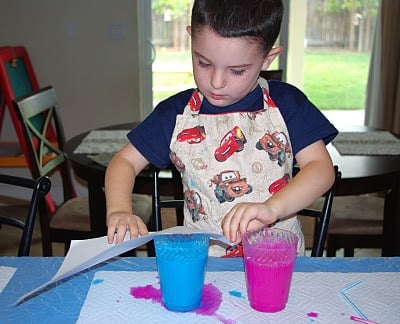 child with cup of paint
