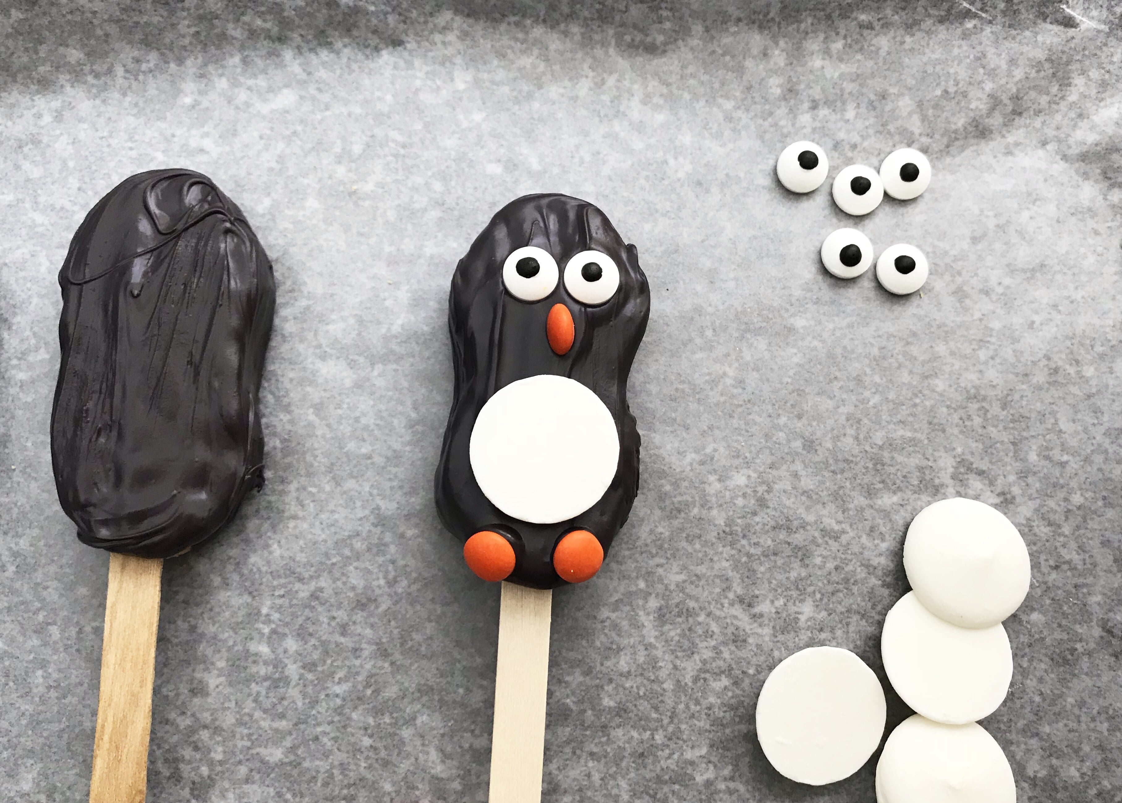 two penguin nutter butter cookies on gray background