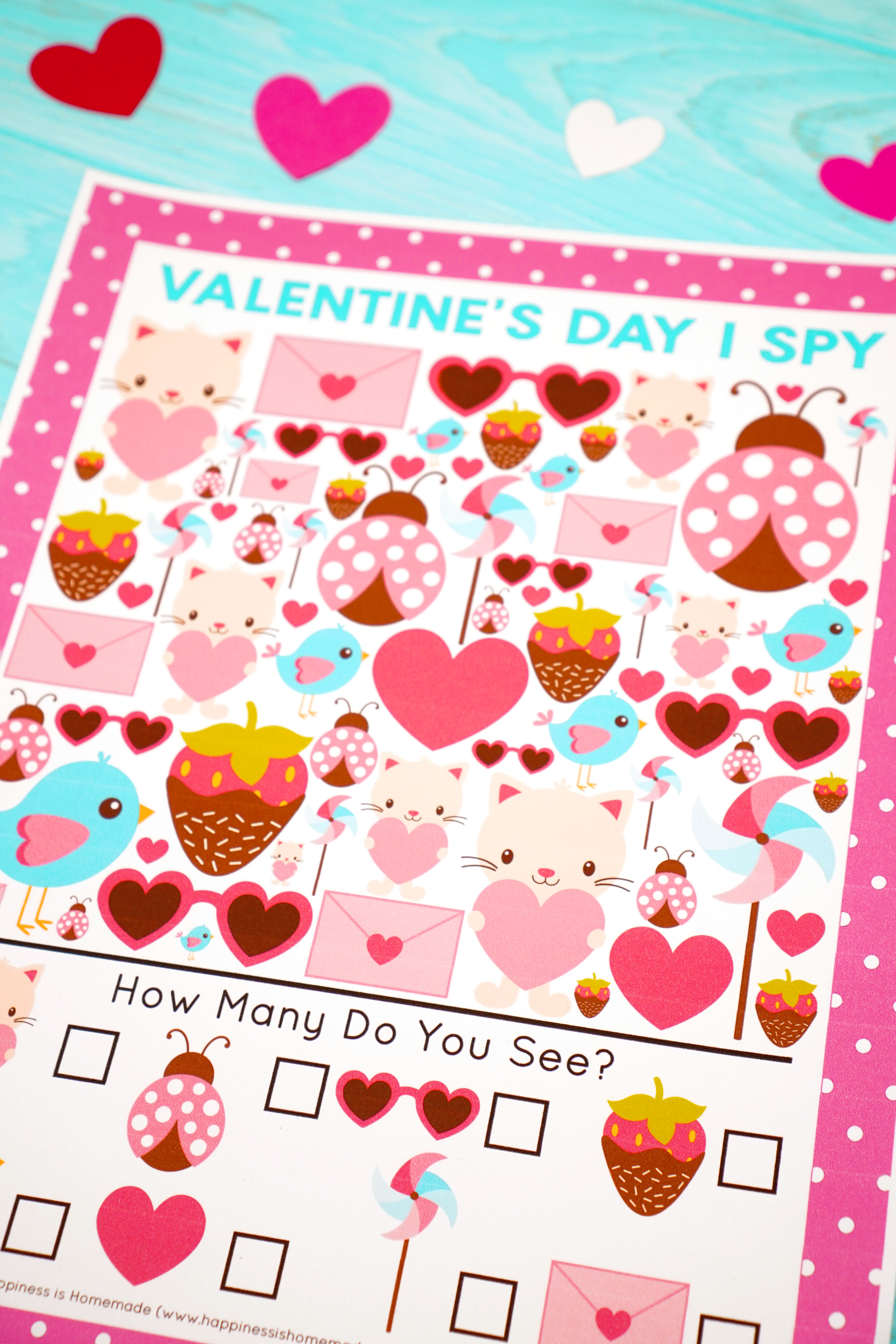 Close up of Valentine's Day I Spy Game on blue background with hearts