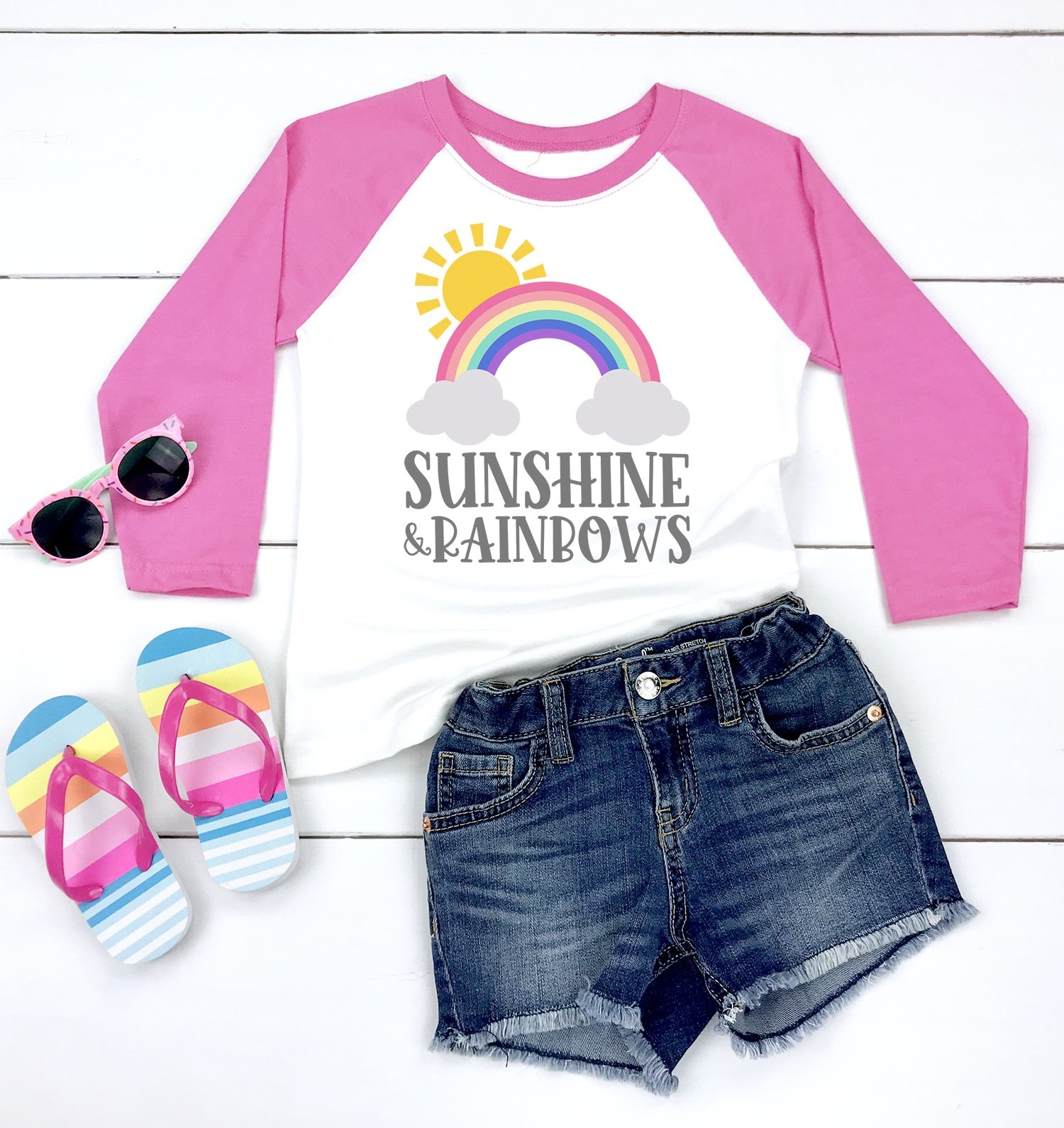 Sunshine and Rainbows pink raglan shirt with denim shorts, striped flip flops, and pink sunglasses