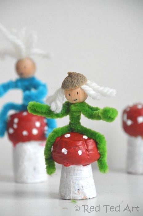 wine cork mushrooms with little pipe cleaner people sitting on top of them