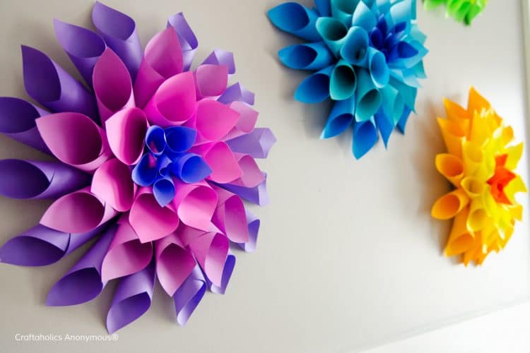 rolled paper tubes made into dahlias on wall
