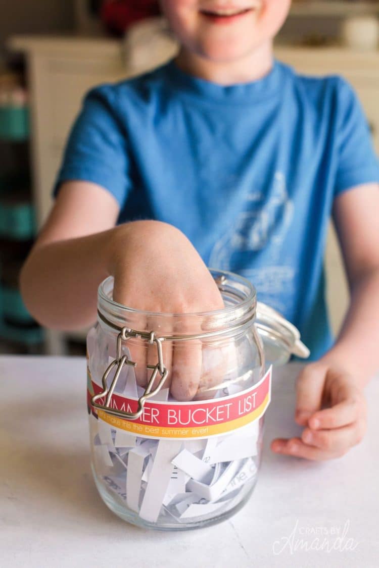 hand reaching into summer bucket list jar 