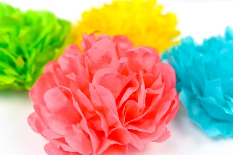 Tissue paper flowers in pink, blue, green, and yellow