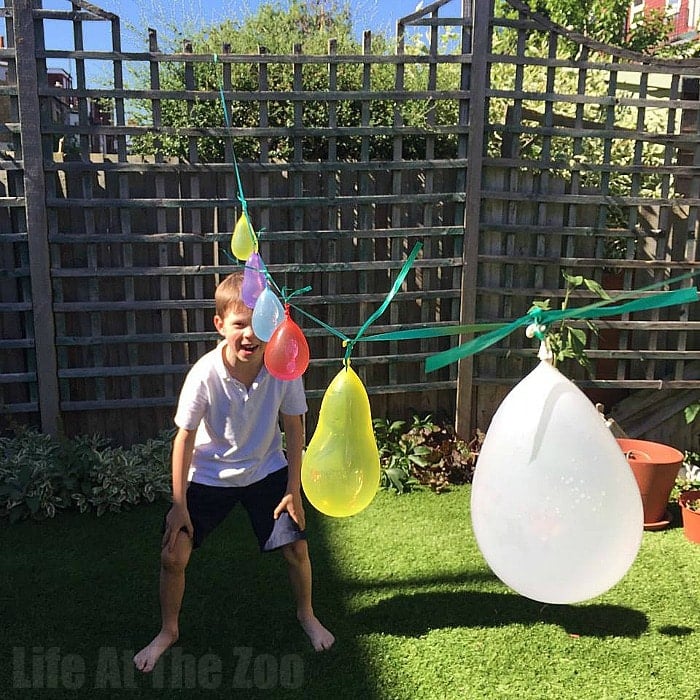 kids playing water balloon pinata game